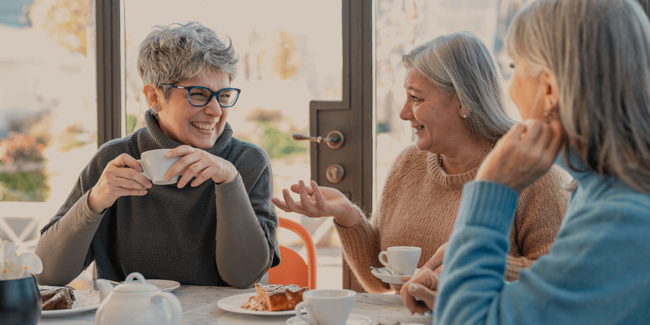 A group of older women drinking coffee in a cafe