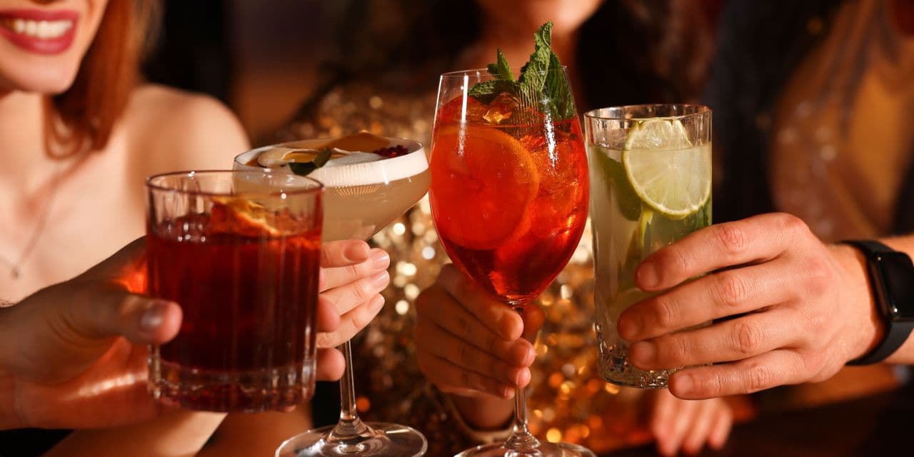 Close up of cocktail as friends cheers on a night out