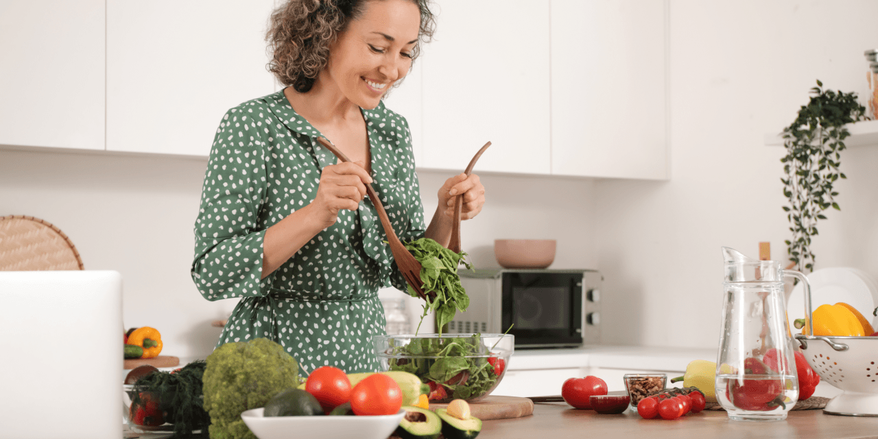 Middle aged woman making a salad 
