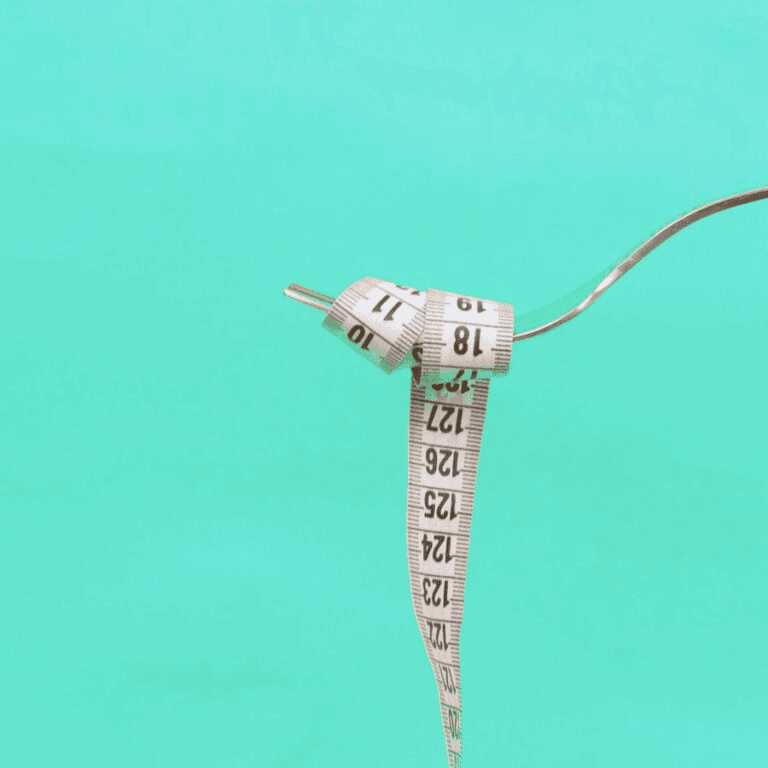 An image of a tape measure on a fork, referring to how many calories needed to lose weight.