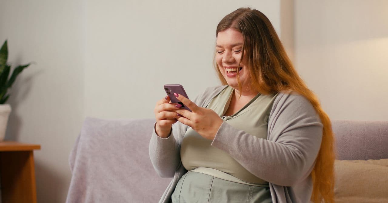 A woman looking at her phone to learn how to claim back her weight loss consultation and medication costs with insurance.