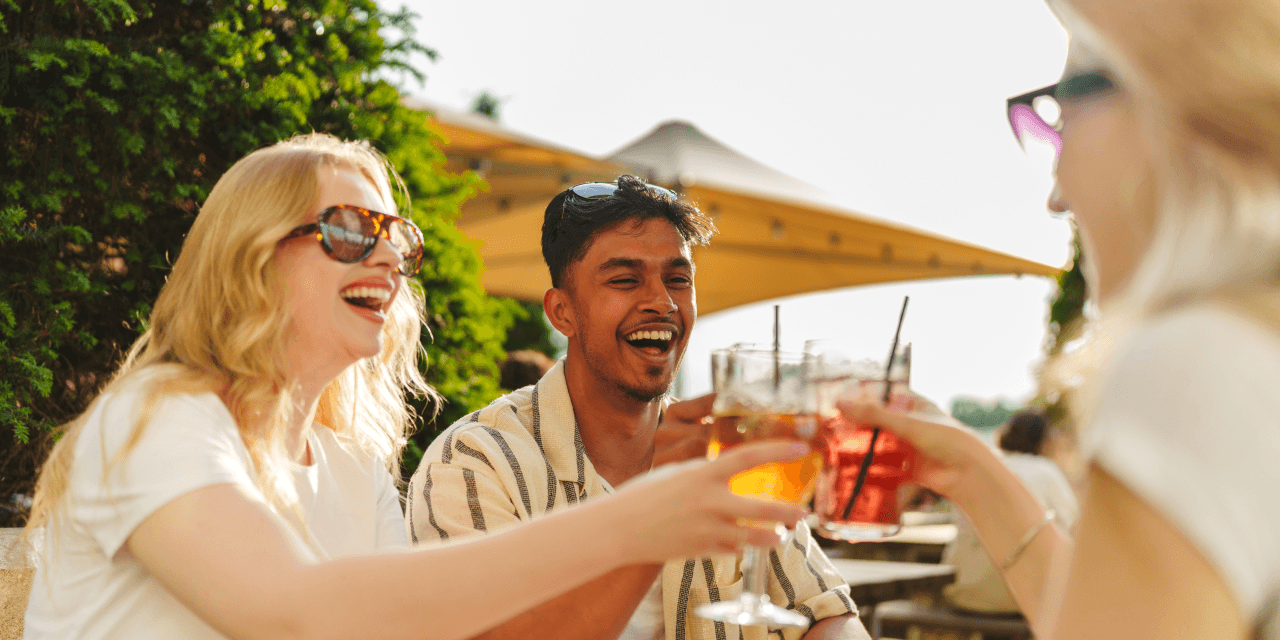A group of friends drinking cocktails on a sunny day