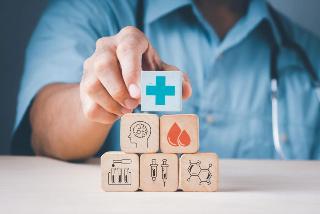 Nurse stacking blocks with health care icons printed on them